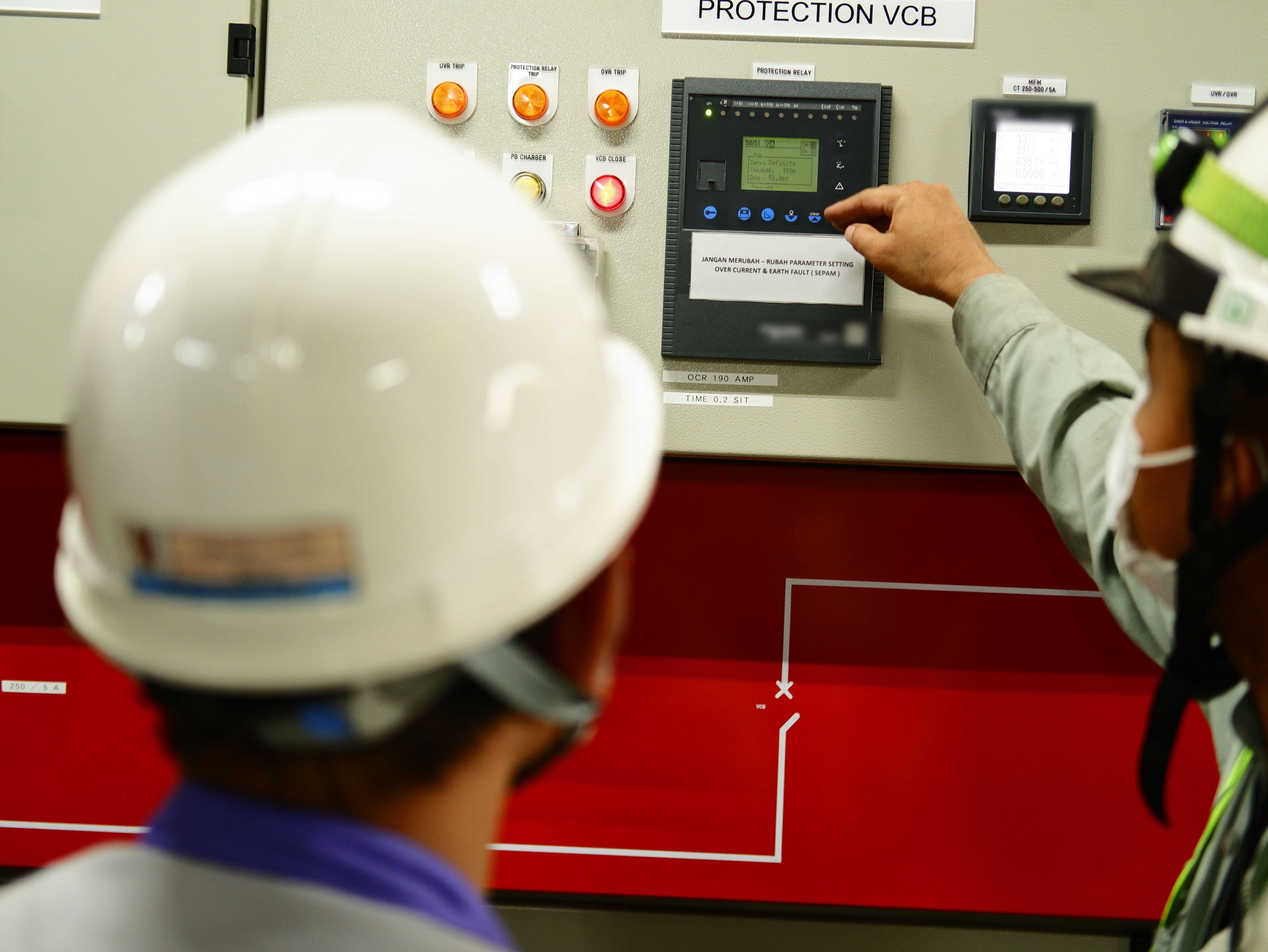 Technician monitoring a protection control panel
