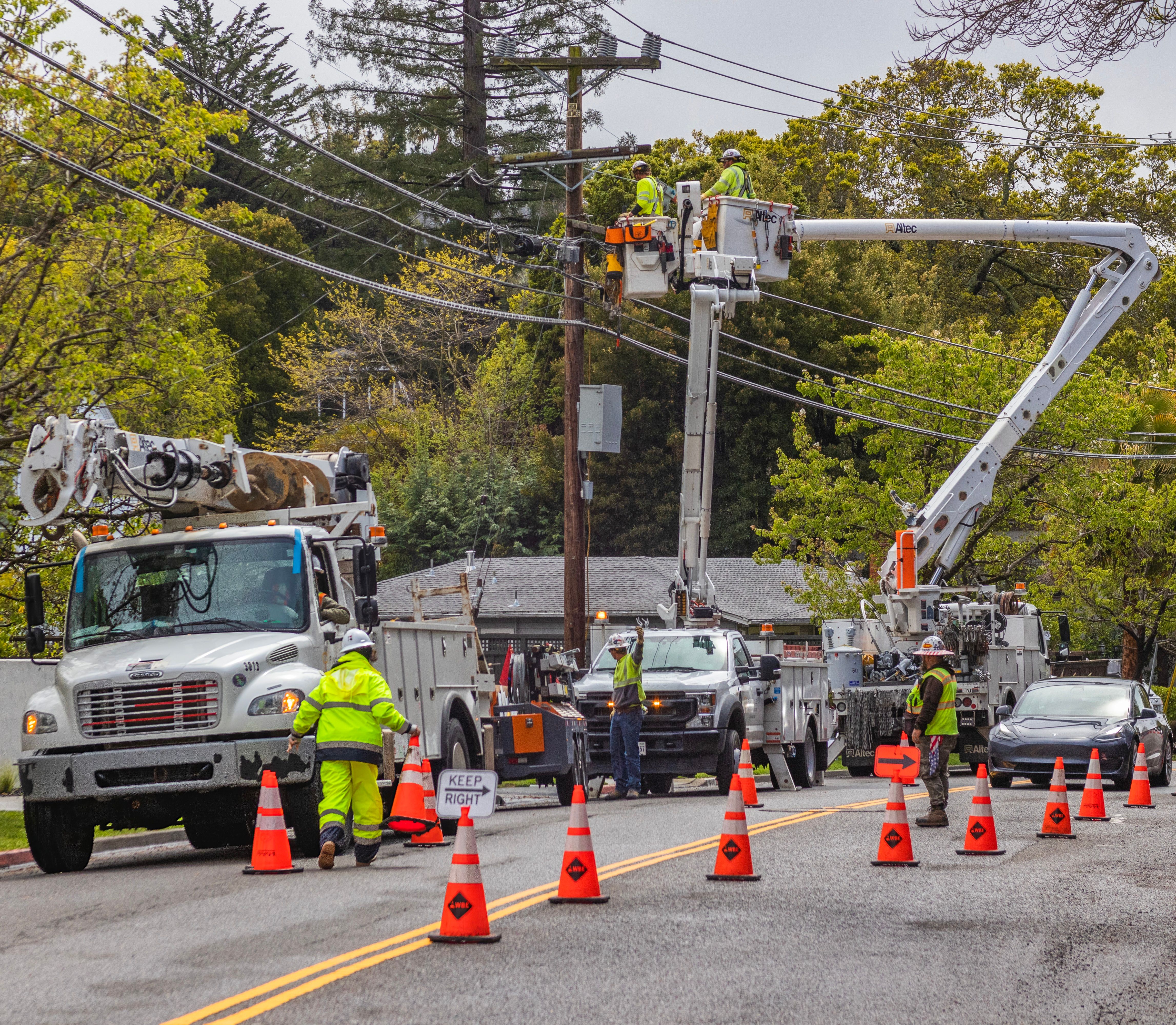 Maintenance crew servicing infrastructure on a residential street