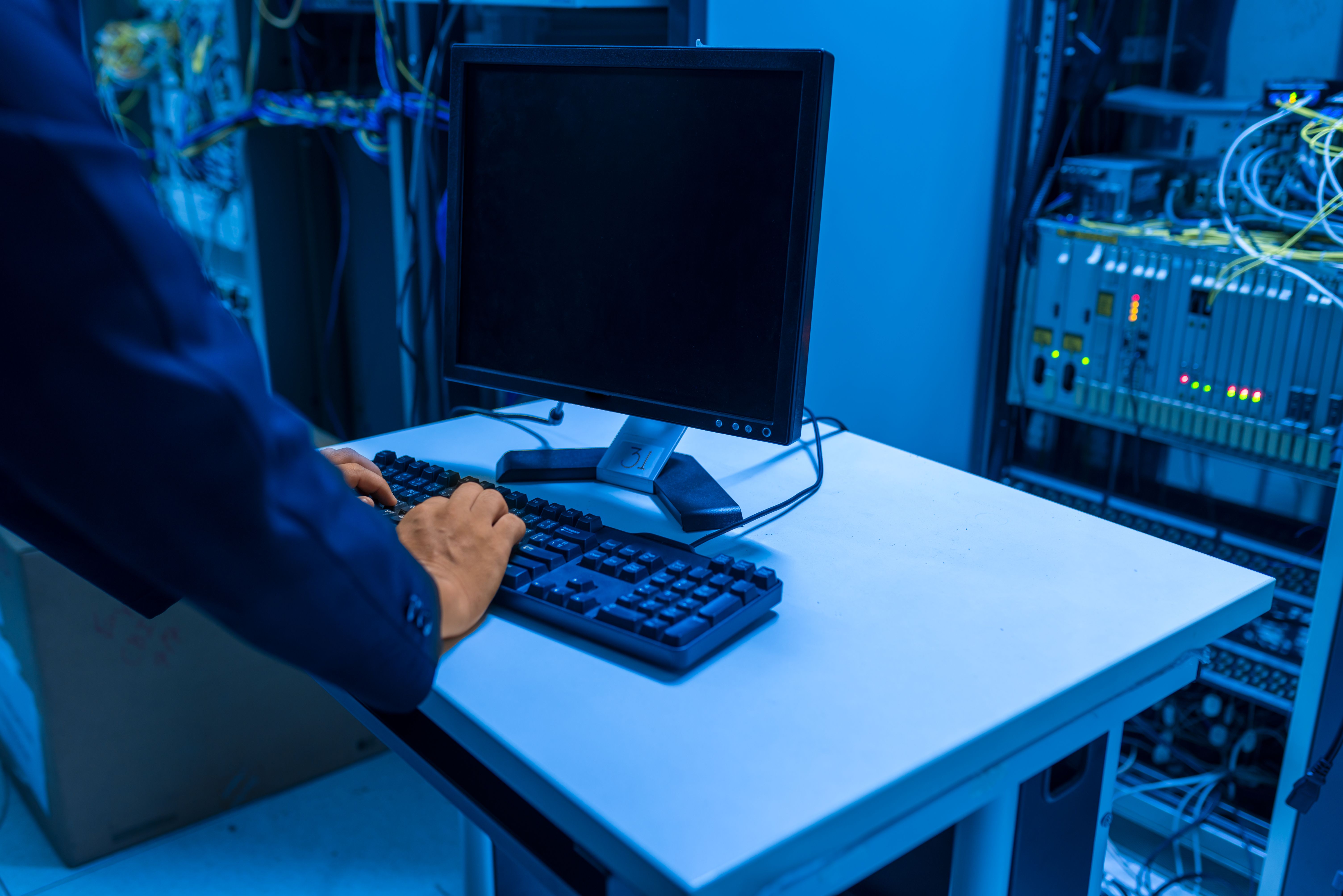 IT technician working in a data center server room